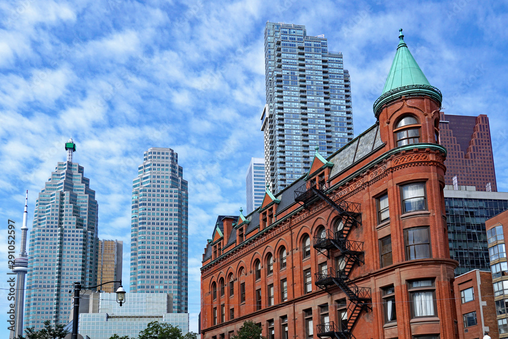 Toronto, financial district skyline in the background with Victorian flatiron building in the foreground Toronto, financial district skyline in the background with Victorian flatiron building in the foreground