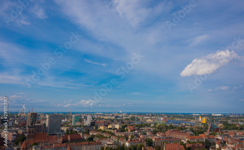 Fototapeta Naklejka Na Ścianę i Meble -  Panorama from the height of the city of Gdańsk, cityscape, cranes, smog, buildings, top-view, buildings, industrial, old town, clouds, urban, aerial, town, port