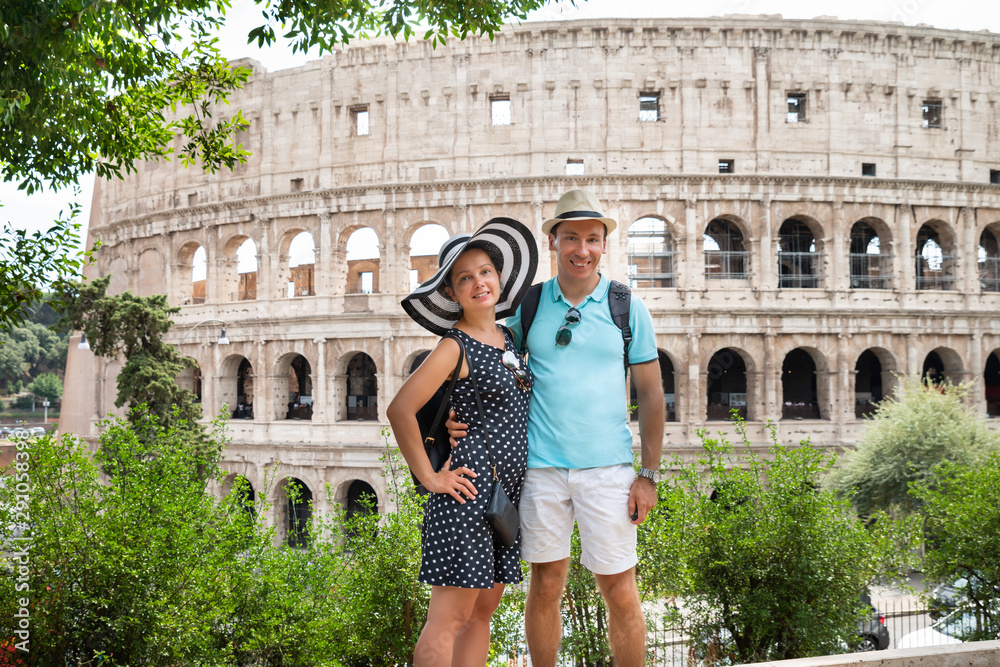 Young Couple Standing In Front Of Colosseum