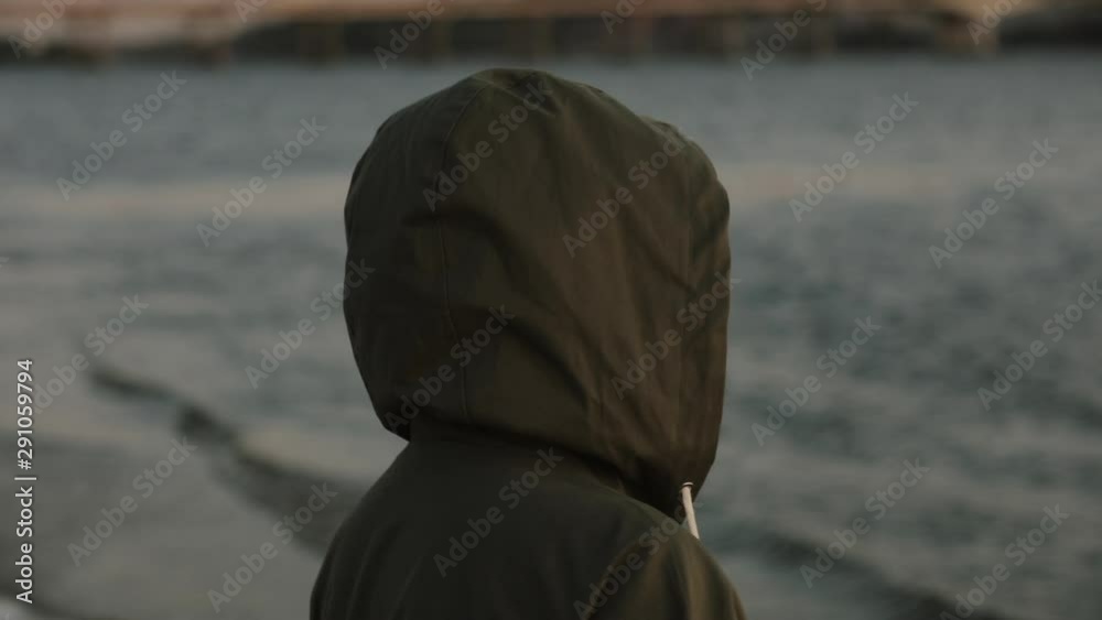 Stylish happy woman in sunglasses laughing standing at the river at fresh autumn evening wear hoodie Stylish happy woman in sunglasses laughing standing at the river at fresh autumn evening wear hoodie