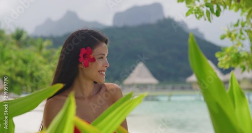 Woman wellness spa skincare Asian natural beauty on tropical beach in French Polynesia, Bora Bora, Tahiti. Shot on RED in SLOW MOTION. photo