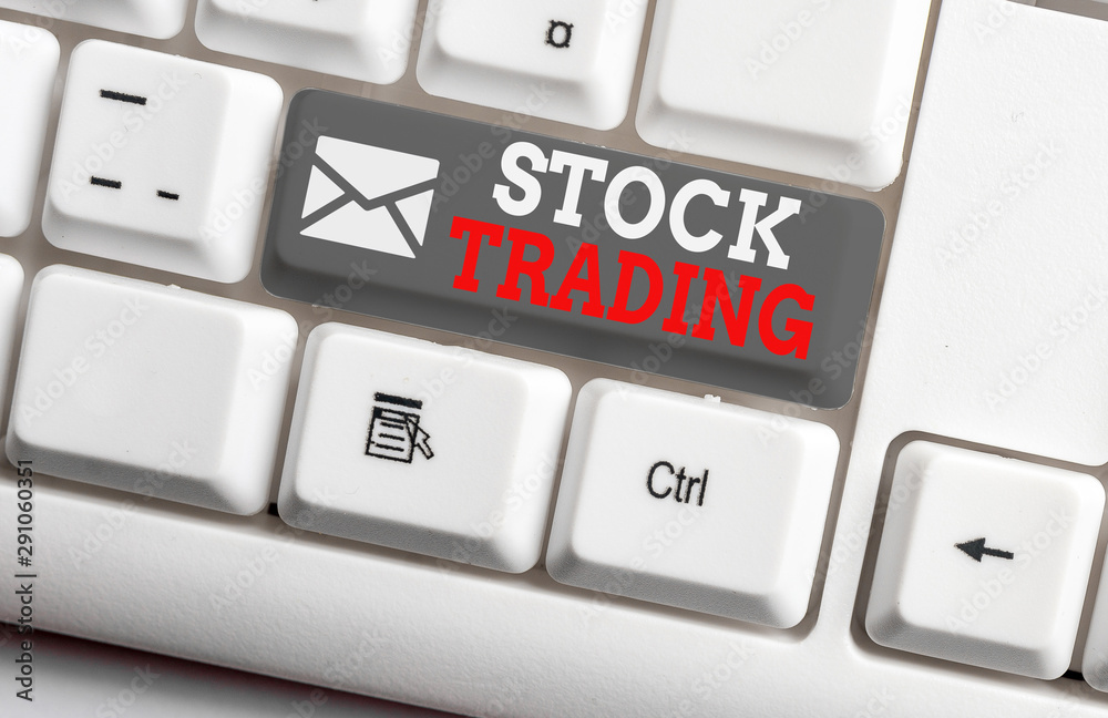 Conceptual hand writing showing Stock Trading. Concept meaning Buy and Sell of Securities Electronically on the Exchange Floor White pc keyboard with note paper above the white background Conceptual hand writing showing Stock Trading. Concept meaning Buy and Sell of Securities Electronically on the Exchange Floor White pc keyboard with note paper above the white background
