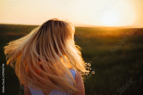 Wallpaper Mural  Blond girl turned to sunset. Close-up Torontodigital.ca
