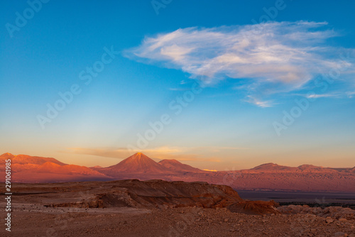 A majestic sunbeam at sunset in the Moon Valley of the Atacama desert with the Licancabur volcano peak  Chile.