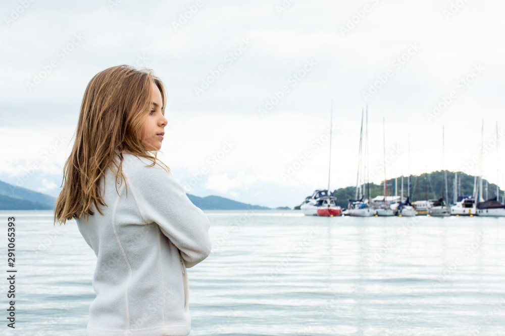 Standing child girl expresses diverse faces of surprise and curiosity. Standing child girl expresses diverse faces of surprise and curiosity.