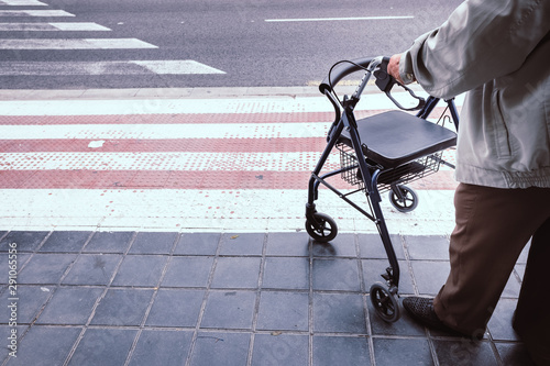 Tablou pe pânză Elderly man alone disabled, using a walker to help him walk.