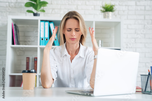 Obraz na plátně young attractive sad and desperate businesswoman suffering stress and headache a