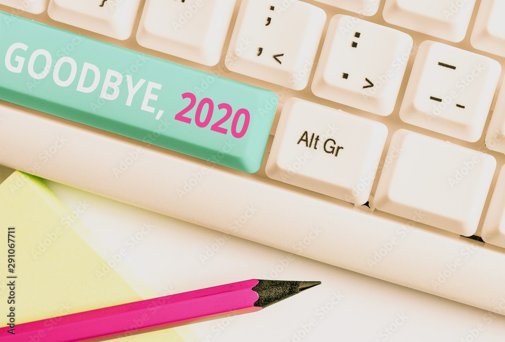 Handwriting text Goodbye 2020. Conceptual photo New Year Eve Milestone Last Month Celebration Transition White pc keyboard with empty note paper above white background key copy space Handwriting text Goodbye 2020. Conceptual photo New Year Eve Milestone Last Month Celebration Transition White pc keyboard with empty note paper above white background key copy space
