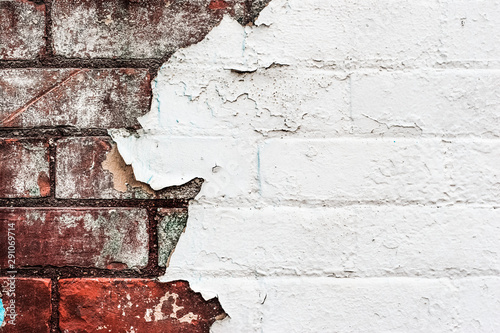 Texture of old peeling paint on a brick wall