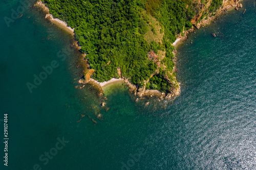 island and green sea top view from drone