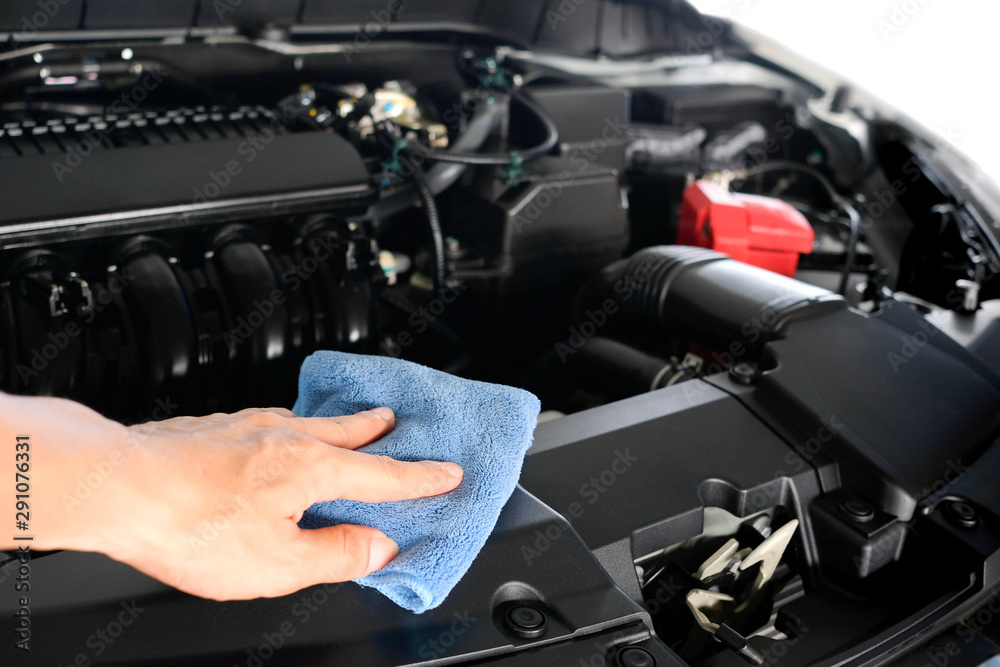 hand of a man holding a blue cloth caring, maintenance car and cleaning And engine car room hand of a man holding a blue cloth caring, maintenance car and cleaning And engine car room