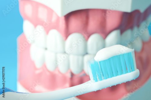 hands of a dentist, he is demonstrating how to brush your teeth properly. To clean the teeth and oral cavity.