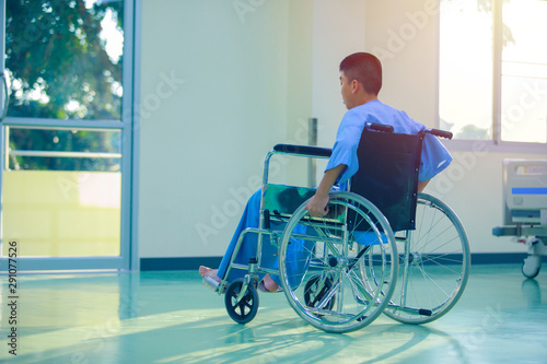 The patients on the wheelchair in the hospital and clean bed background, the patients with modern medical equipment in the hospital