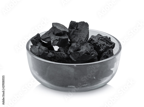 wood charcoal in the glass bowl isolated on white background photo