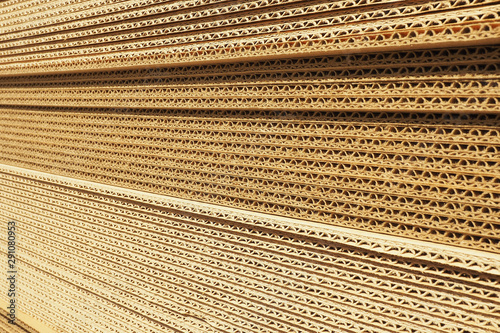 Background and texture of a stack of packaging cardboard in the sun...