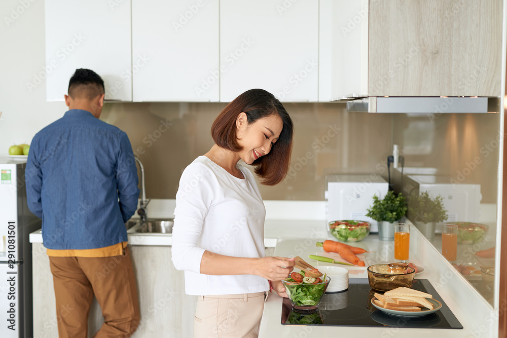 Young couple spending morning time together in their kitchen at home