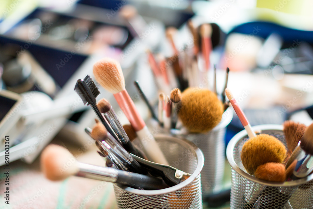 Close up of a set of make up brushes against a bokeh background - obrazy, fototapety, plakaty 