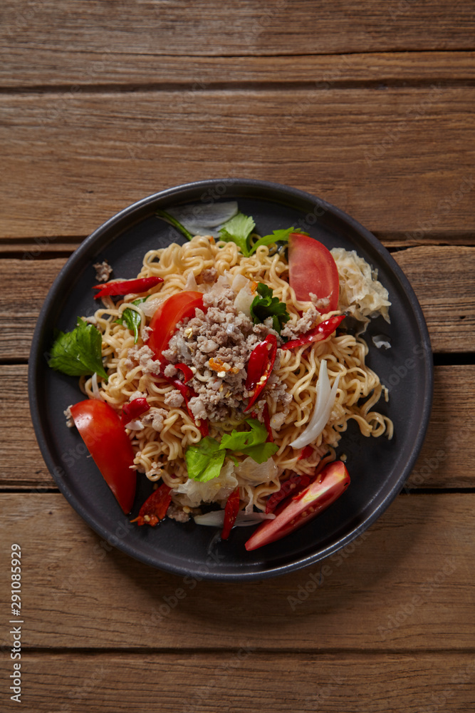 Spicy mama salad with pork on wood table,Spicy noodle. Spicy mama salad with pork on wood table,Spicy noodle.