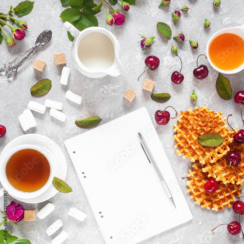 Tea, honey, cherry, milk and wafers. photo