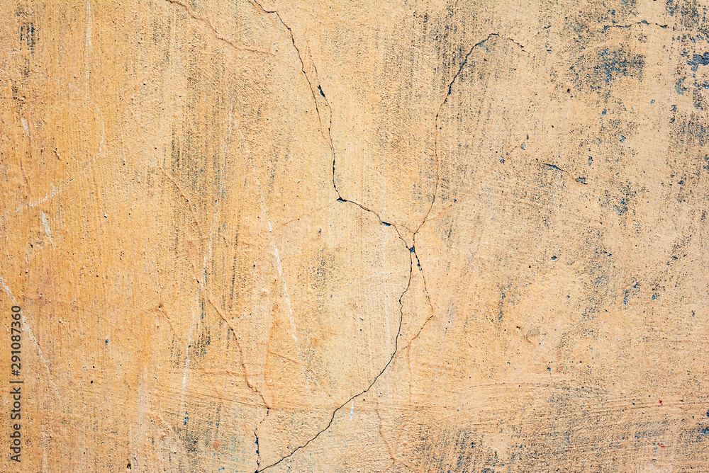 Texture of a concrete wall with cracks and scratches which can be used as a background Texture of a concrete wall with cracks and scratches which can be used as a background