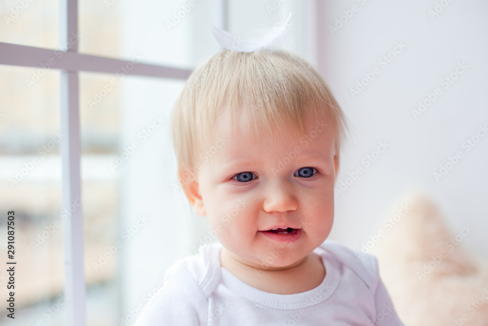 large portrait of a small child on the window