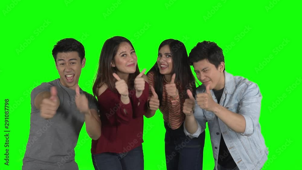 Group of cheerful young people showing thumbs up together at the camera in the studio. Shot in 4k resolution Group of cheerful young people showing thumbs up together at the camera in the studio. Shot in 4k resolution