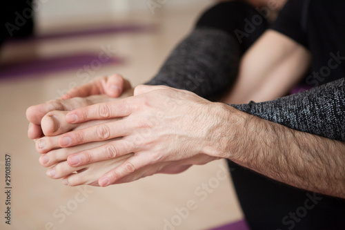 Yoga position, close up of hands and legs at yoga studio