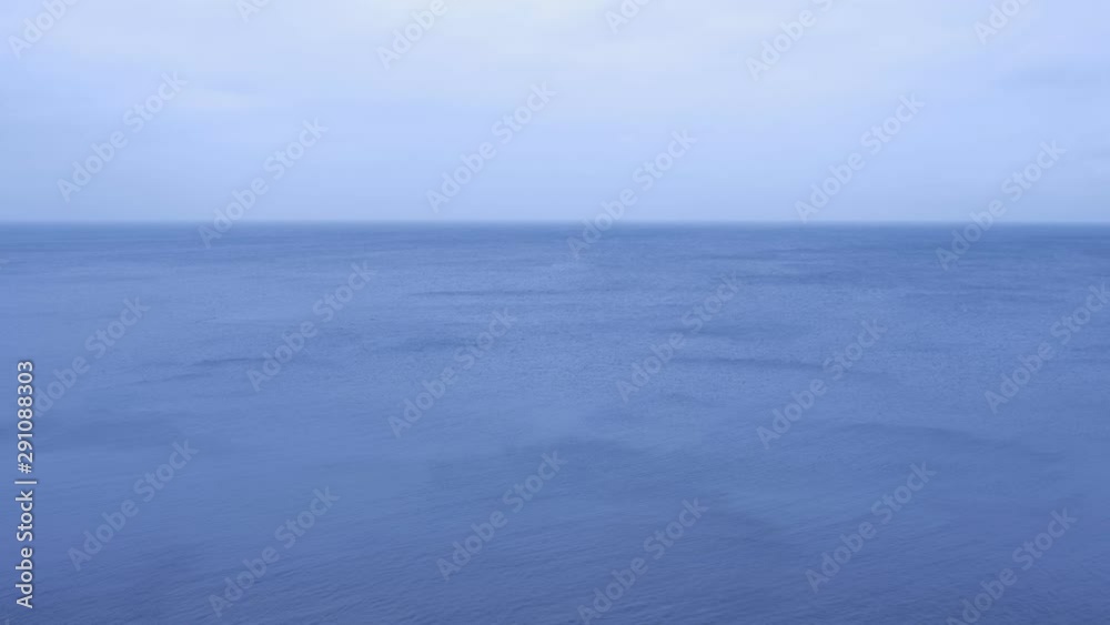 Nature background with sky and waves on blue sea surface coming from the shore. Beautiful seascape with blue sea and light blue cloudy sky. Beautiful blue ocean water. Nature background with sky and waves on blue sea surface coming from the shore. Beautiful seascape with blue sea and light blue cloudy sky. Beautiful blue ocean water.