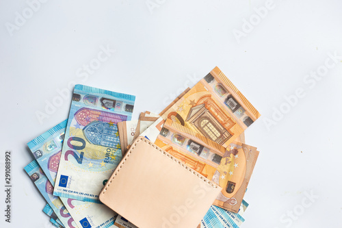 Leather wallet with euro money bill on white background photo