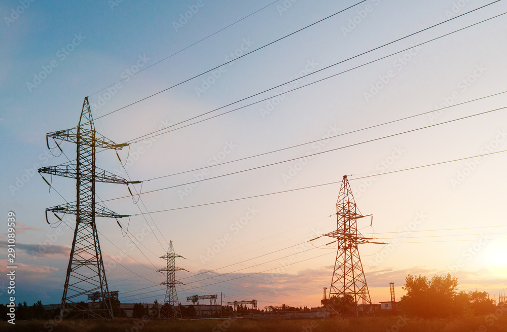 Silhouette High voltage electric tower on sunset time and sky on sunset time background.