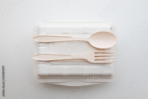 Biodegradable plastic spoon, fork and lunch box on white background isolate