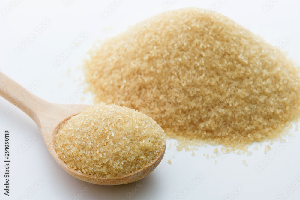 Brown sugar background with wooden spoon Brown sugar background with wooden spoon