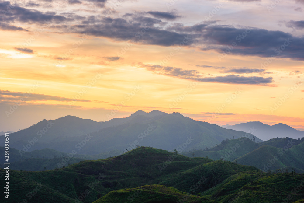Fototapeta premium Silhouette of Mountain With Fluffy Clouds during Sunrise at Noen Chang Suek, Kanchanaburi, Thailand