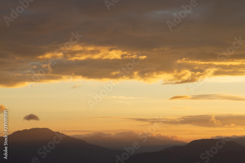 Silhouette of Mountain With Fluffy Clouds during Sunrise