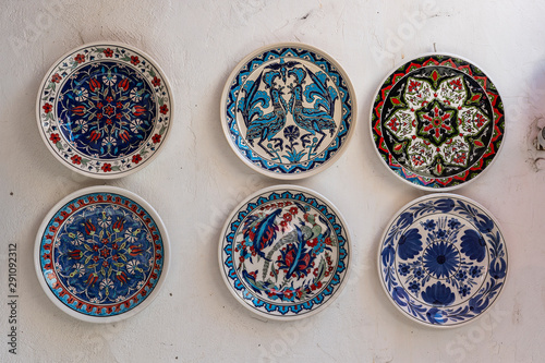 Traditional greek ceramic plate on white wall in a street . Kos island, Greece