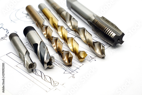 Professional cutting tools used for metalwork. Multi-flute drill, broach bit, Stainless Drill bit, Tap for thread photo