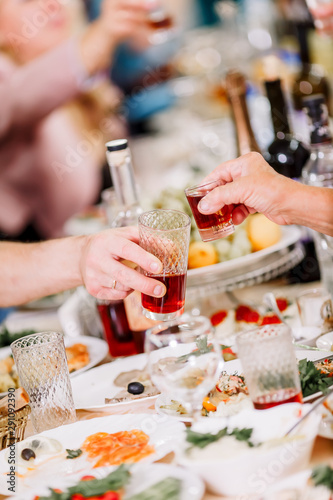 Hands holding glasses and toasting, happy festive moment, luxury celebration concept. Clinking glasses of champagne in hands.