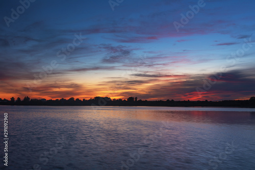 Morning scenery on a cozy lake with beautiful fogs