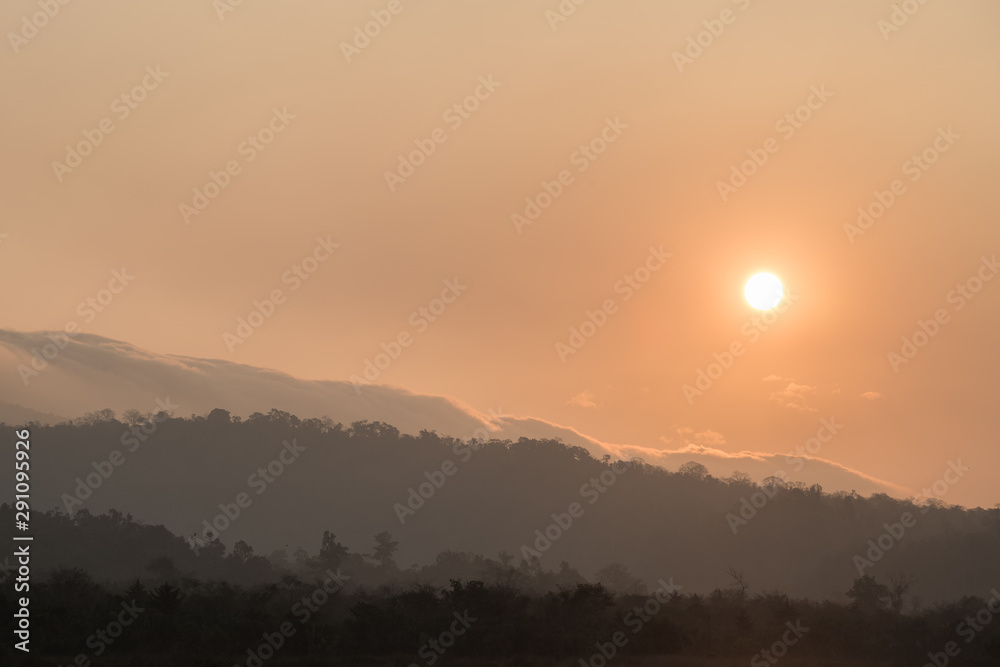 Fototapeta premium Silhouette of Mountain With Fluffy Clouds during Sunrise
