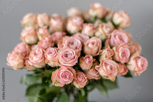Pink roses in glass vases. Bunch pastel color. the concept of a florist in a flower shop. Wallpaper. © malkovkosta