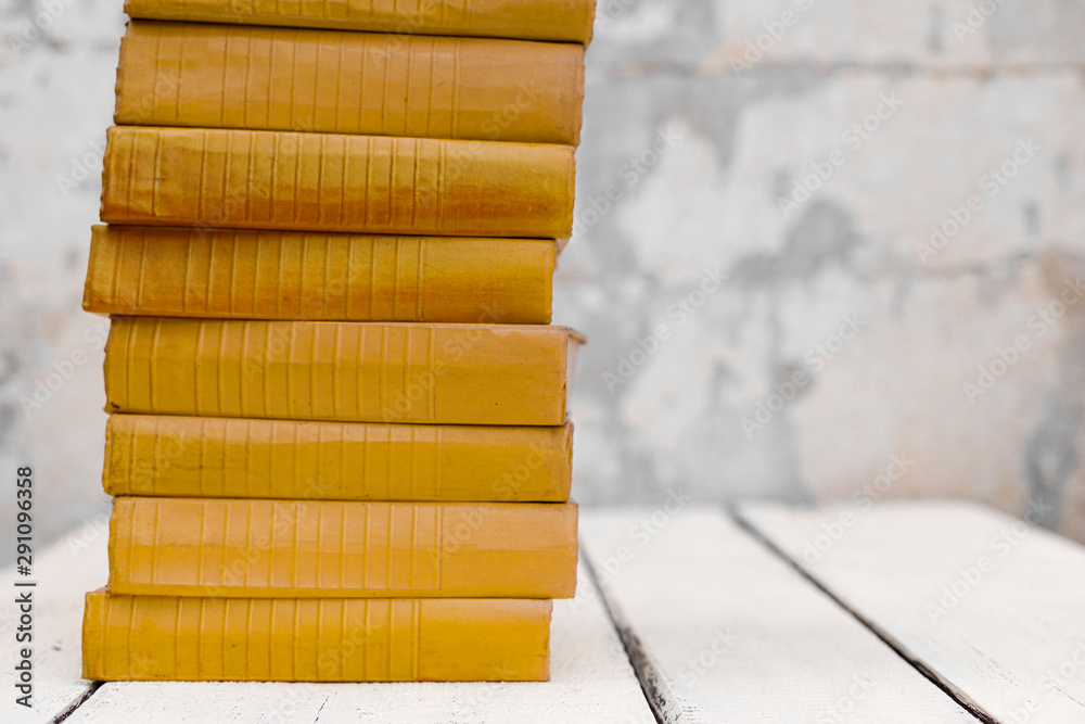 Stack of old ancient shabby books on a white wooden background. Stack of old ancient shabby books on a white wooden background.