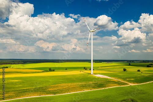 Big wind turbine on field in the summer, aerial view