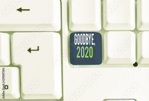 Word writing text Goodbye 2020. Business photo showcasing New Year Eve Milestone Last Month Celebration Transition White pc keyboard with empty note paper above white background key copy space photo