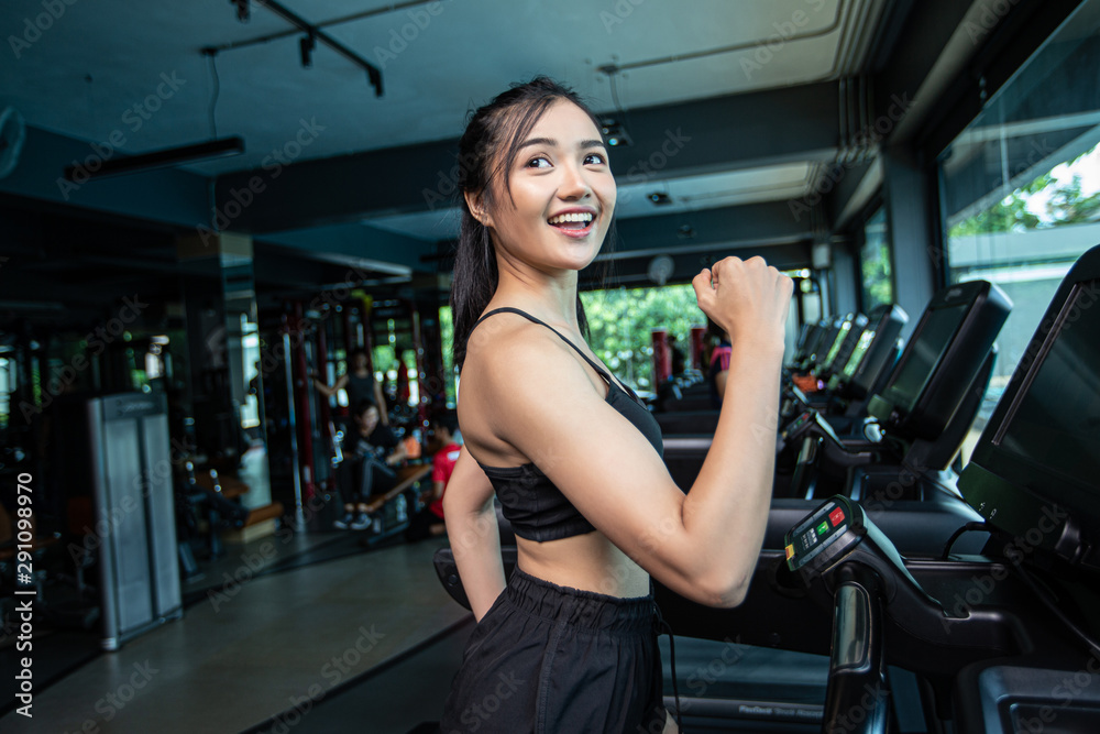 Fototapeta premium Women jogging on the treadmill in the gym