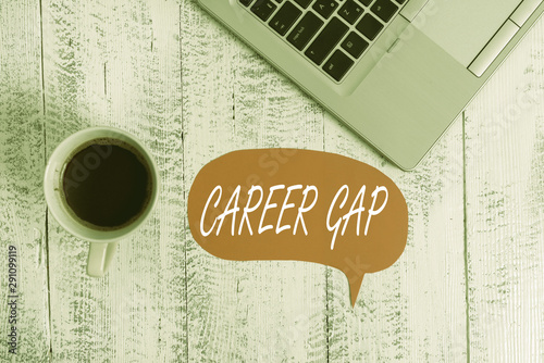 Word writing text Career Gap. Business photo showcasing A scene where in you stop working by your profession for a while Trendy metallic open laptop speech bubble vintage wooden table coffee cup photo