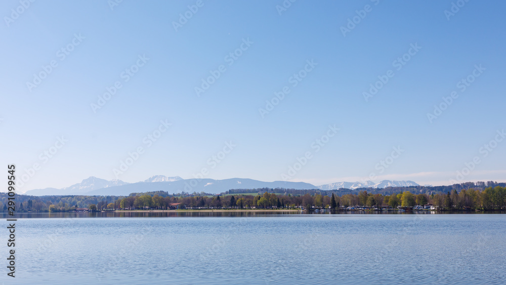 Lake Waginger See with mountains in background at sunny spring day