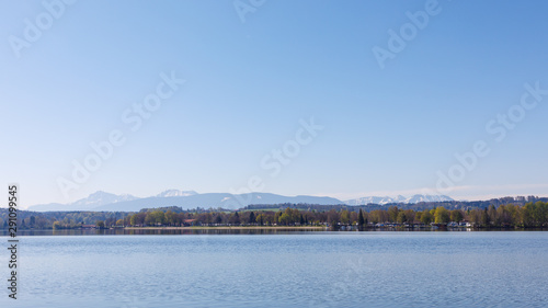 Lake Waginger See with mountains in background at sunny spring day