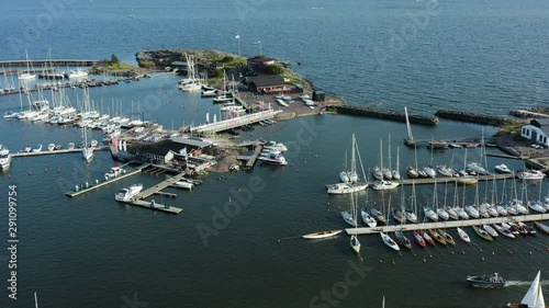 Aerial, reverse, drone shot, over boats at the Merisatama harbor, on a sunny, summer day, in Helsinki, Uusimaa, Finland
 photo