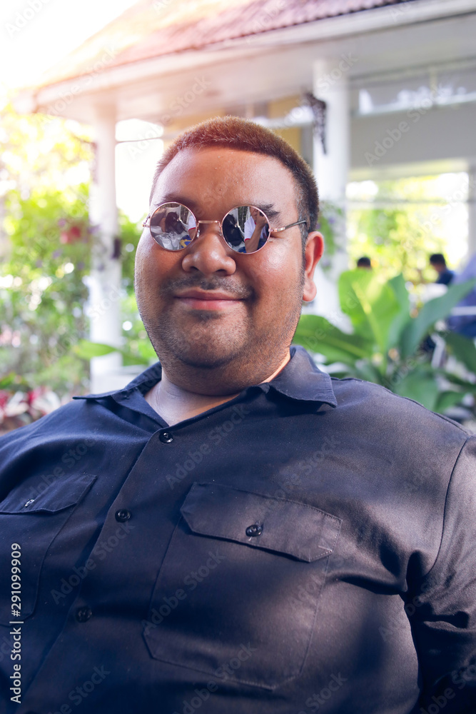 Fat people wearing black clothes are smiling. Happy, fat people with  glasses. Stock Photo | Adobe Stock