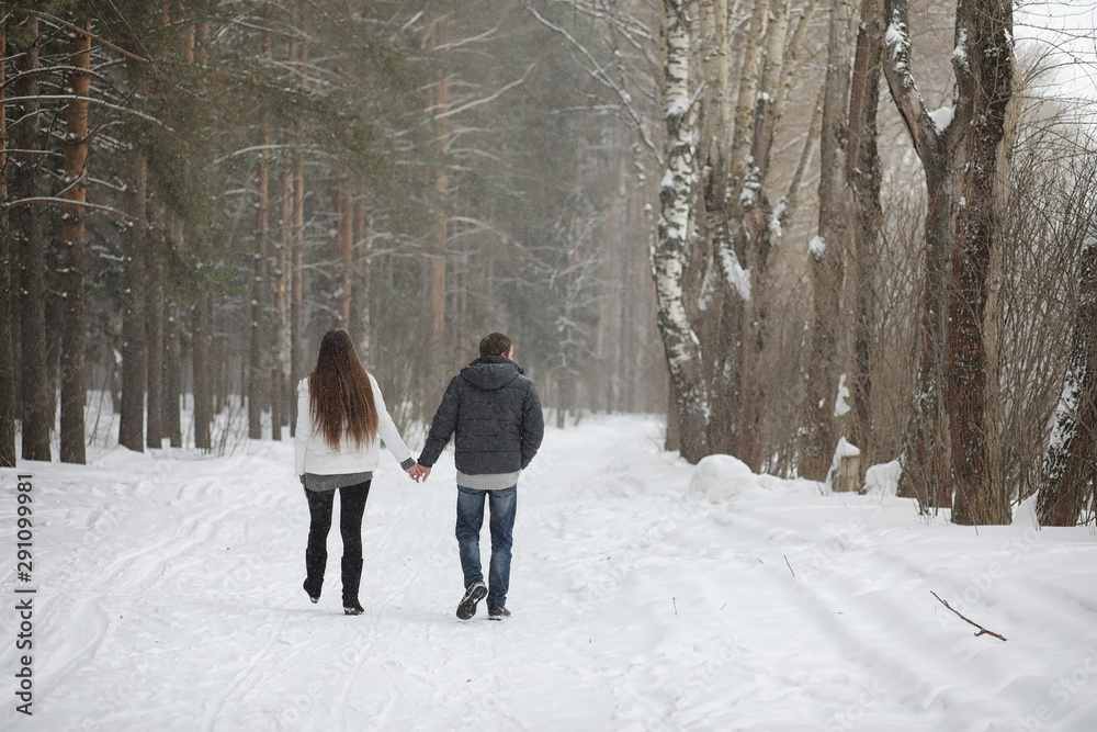 pair of lovers on a date winter afternoon in a snow blizzard pair of lovers on a date winter afternoon in a snow blizzard